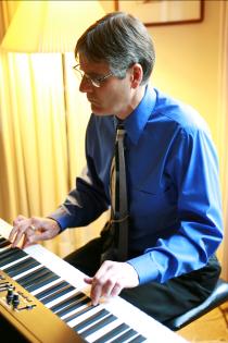 Close-up of Peter Torpey playing electric piano at a gig